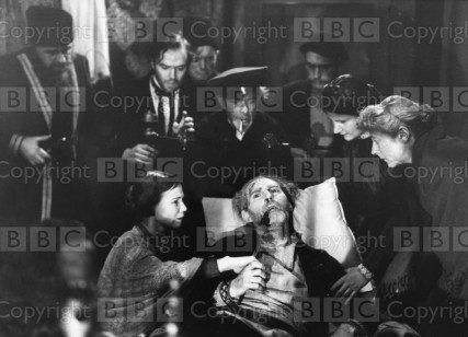 Origin Date: 1953-01-01 Annotation: Picture shows Marmeladoffs death scene from a 1953 BBC adaptatino fo Crime and Punishment by Dostoevsky. (Foreground): Frances Hyland as Sonia and Kenneth Hyde as Marmeladoff. (Background): Eugene Leachy as Coachman, Kenneth Griffin as Raskolnikoff, Ternece Greenidge, Dodd Mehan and Peter Augustine as the three men who brought Marmeladoff back and Sylvia Coleridge as an old woman. Personalities: Hyland, Frances; Hyde, Kenneth; Leahy, Eugene; Griffith, Kenneth; Greenidge, Terence; Mehan, Dodd; Augustine, Peter; Coleridge, Sylvia Location: GB Ref Number: 1438399